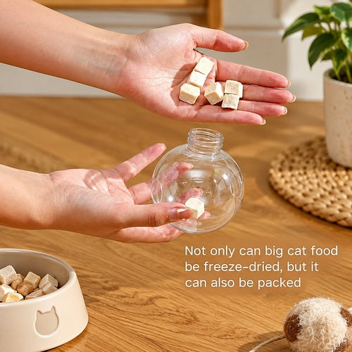 Cat leaky treat ball — hand holding treat ball close-up